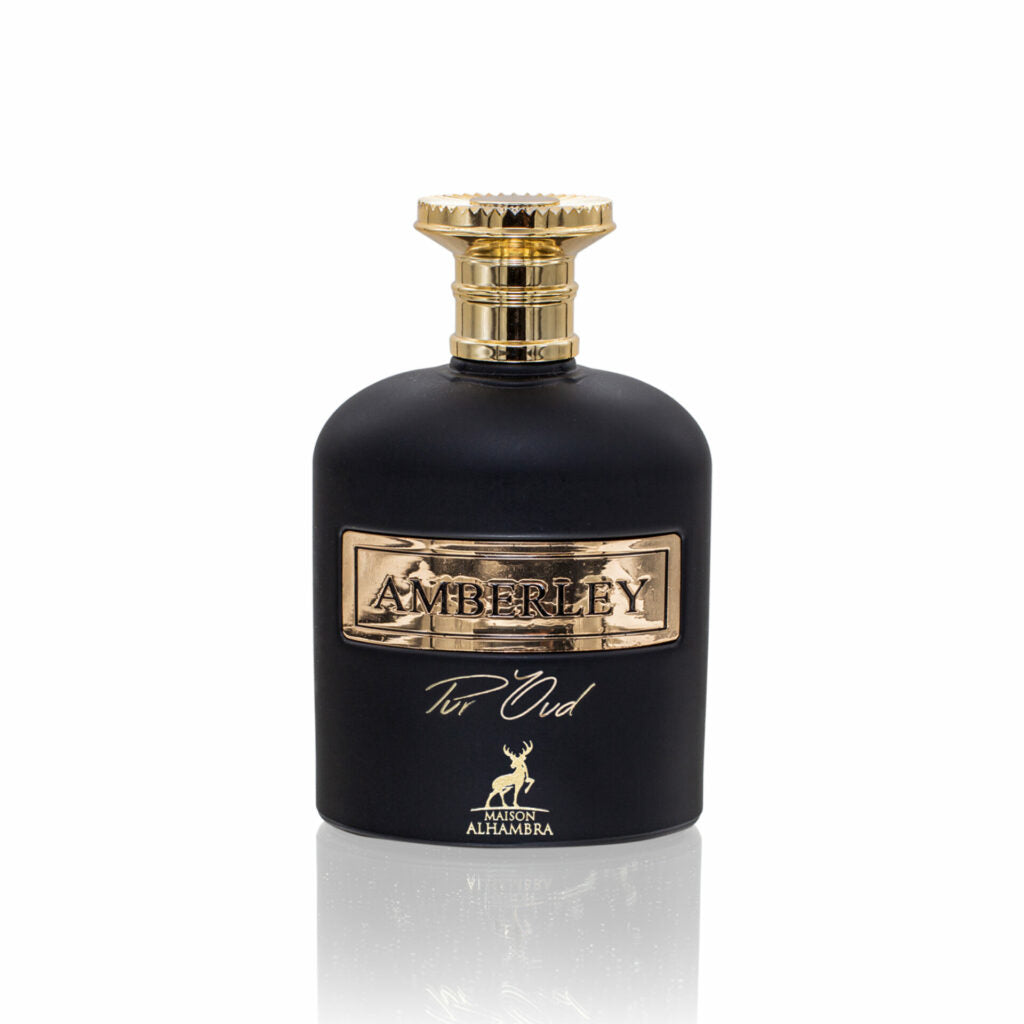 This is an image of a perfume bottle labeled "Amberley Pur Oud" from Maison Alhambra. The bottle is dark, possibly black, with golden accents. The cap is round and golden with a textured design. The label features the brand name "Amberley" in large, golden, embossed letters, and below it, "Pur Oud" in a smaller, elegant script. A small golden emblem of a stag is displayed below the text.