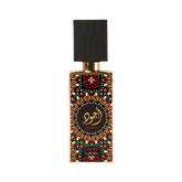 Image of a perfume bottle with a distinctive design. The bottle features a geometric and floral pattern in orange, black, and teal, with a circular black label in the center that has gold Arabic calligraphy and the word 'AJWAD' beneath it. The brand 'Lattafa' is written at the bottom. The cap is black with a textured appearance, resembling wood, and a gold neck. The background is pure white.