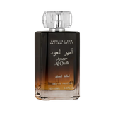A close-up view of the Ameer Al Oudh by Lattafa Perfumes bottle. The perfume bottle has a gradient color scheme, transitioning from light amber at the base to dark brown towards the top. The bottle has a clear, faceted cap and silver text in both Arabic a