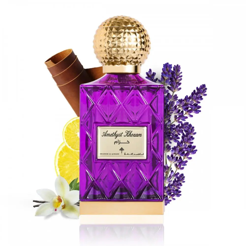 The image depicts a vibrant purple glass perfume bottle with a textured gold cap, labeled "Amethyst Khozam" in both Arabic and English script, suggesting the fragrance's name by the brand Ibraheem Al Qurashi. The bottle has a faceted design, reminiscent of cut amethyst gemstones. Accompanying the bottle are elements that hint at the scent's composition: a bundle of cinnamon sticks to the left, a slice of lemon in front, a white orchid flower at the bottom, and sprigs of lavender to the right.