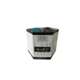 The image shows a hexagonal-shaped cream box from Ard Al Zaafaran. The box is primarily white with a black top. The center of the box features Arabic calligraphy in black, and below that, in English, it says "ANA ABIYEDH." At the bottom of the box, "20 GRAMS" is printed in a smaller font. The box has a turquoise-colored design along the top edge. There's a small, faded graphic and text on the left side of the box that appears to be part of the product branding.