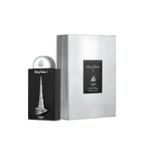 The image shows a perfume bottle and packaging from Lattafa Pride, branded as "Art of Arabia I." The perfume bottle has a sleek black design with a silver depiction of a tall, iconic skyscraper, resembling the Burj Khalifa, embossed on the front. The bott