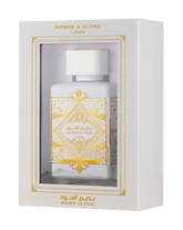 This image displays a perfume package with a white rectangular box that has a window showing the bottle inside. The box is labeled "HONOR & GLORY Lattafa" at the top, with intricate gold geometric and floral designs around the window and on the lower part