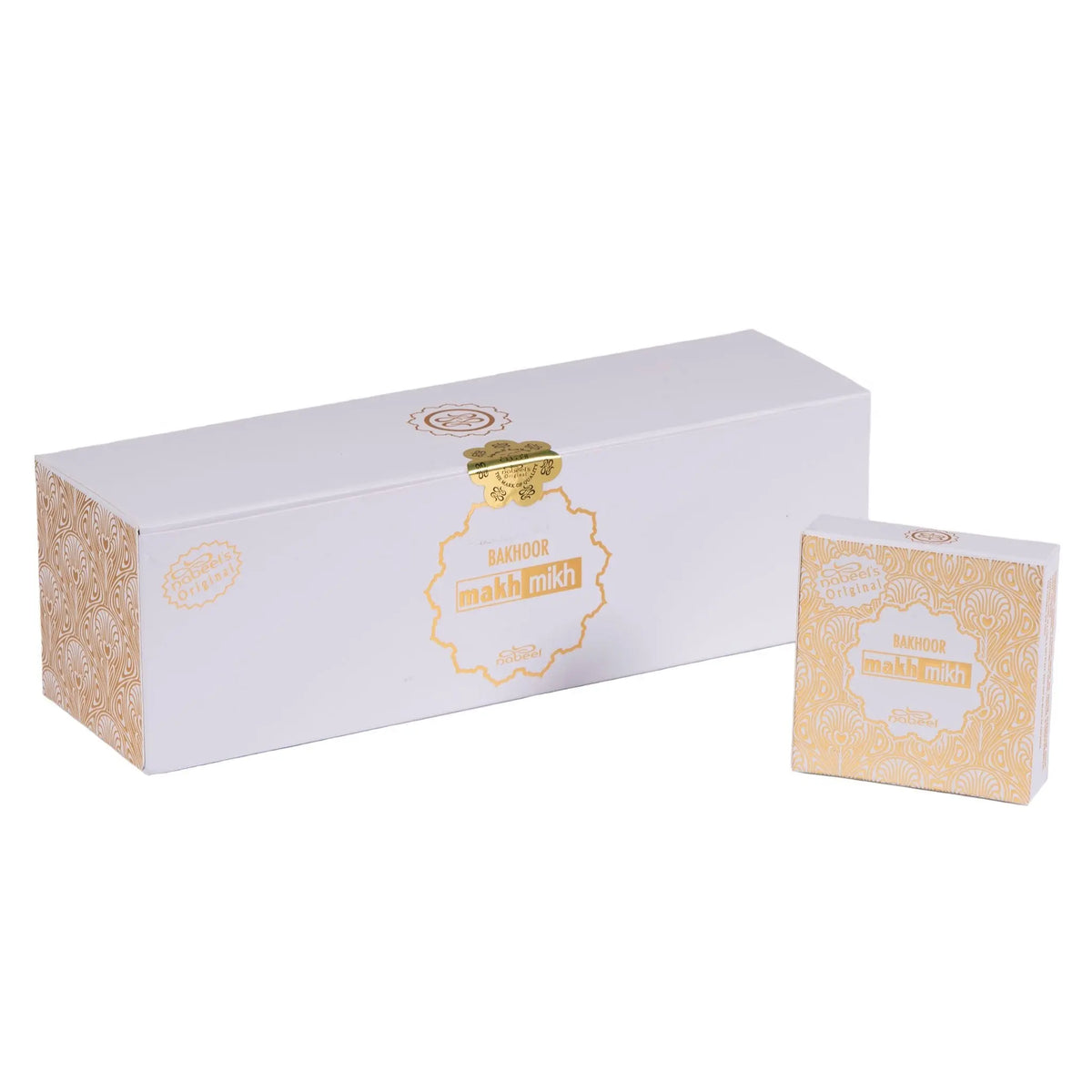 An elegant product packaging set for "Bakhoor Makh Mikh" by Nabeel Perfumes. The set includes a long, rectangular box and a smaller square box, both with a pristine white background and embellished with golden ornamental patterns. The central feature on both boxes is an intricate, golden label that reads "BAKHOOR makh mikh" in stylized lettering. The label's border has a decorative, lace-like design, adding a touch of opulence to the packaging.