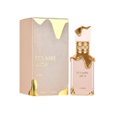 A tall, light-beige perfume bottle with gold drips adorning the cap and collar, displayed next to its matching beige-and-gold box labeled “Eclaire” by Lattafa.