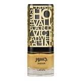 The image shows a bottle of perfume. The bottle has a clear bottom filled with yellow-amber colored liquid, presumably the fragrance. It features a detailed, ornate, gold-colored metallic overlay with cut-out letters and designs, and a black band towards the top, under the cap. The name "JASOOR" is prominently displayed in the middle of the bottle, with the brand "Lattafa" written at the bottom. The overall design suggests a luxurious and perhaps Middle Eastern-inspired aesthetic.