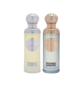 The image features two perfume bottles from the Gissah collection, "Hudson II" and "Imperial II." Both bottles have tall, cylindrical shapes with ornate silver caps featuring embossed designs. "Hudson II" has a light yellow tinted glass body with a silver medallion, and "Imperial II" has a light blue tinted glass body with a copper medallion. Each bottle is labeled with its respective name in elegant font at the bottom.