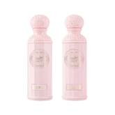 The image features two light pink perfume bottles from the "Legend of the Sky for Her" collection by Gissah, named "Sora" and "Ellora." The bottles have a cylindrical shape with detailed ornamental designs embossed on the silver caps and the central gold medallions. The names "Sora" and "Ellora" are inscribed on gold plaques at the base of each bottle.