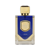 The image features a bottle of Liam Blue Shine perfume by Lattafa. The bottle has a clear, rectangular glass base with a blue color gradient at the top half. It features a prominent gold label with a textured border and the name "Liam" in stylized font in the center. Below the label, the word "Lattafa" is printed in small, simple white letters. The cap of the bottle is a smooth, metallic gold color with a faceted design, giving it a luxurious and elegant appearance.