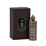 A brown rectangular perfume box labeled 'Mughal Fort' from the Niche Emarati Perfumes collection by Lattafa. The bottle design mimics a Mughal-style fort with intricate architectural detailing. The product label is displayed on a gold and black plaque, an