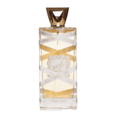 The image displays a rectangular perfume bottle with a golden-yellow liquid inside. The cap is a geometric, faceted gold design. A white ribbon with the text "Musk Mood" in a repeating pattern wraps around the bottle. Additionally, a decorative gold label with elaborate borders and an emblem is affixed to the center of the bottle.
