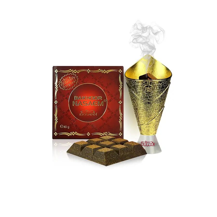 The image features "Bakhoor Nasaem" by Nabeel Perfumes. It includes a maroon square box with ornate golden borders and patterns, the product name in both Arabic and English, and the weight "40g" indicated on it. Beside the box is a golden textured bakhoor burner with smoke rising from the top, signifying the product's aromatic function. In front of the box, several pyramid-shaped pieces of bakhoor are displayed, revealing their dark color and textured surface.