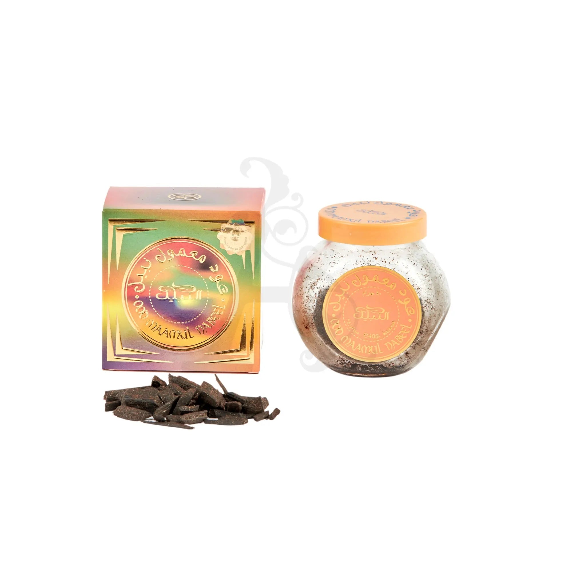 The image displays a product set from Nabeel Perfumes, consisting of Oud Ma'amoul Bakhoor. On the left, there's a holographic box with a square shape and the Nabeel logo in Arabic and English, along with decorative elements that suggest a premium quality product. To the right, there's a glass jar with a metallic orange lid, labeled in Arabic and English with the Nabeel brand, indicating it contains the bakhoor.