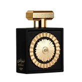 The image features a sophisticated perfume bottle with a black rectangular body and a distinctive golden circular motif in the center, resembling a sun or wheel design. The bottle has a textured gold cap with geometric shapes. Arabic script on the bottom