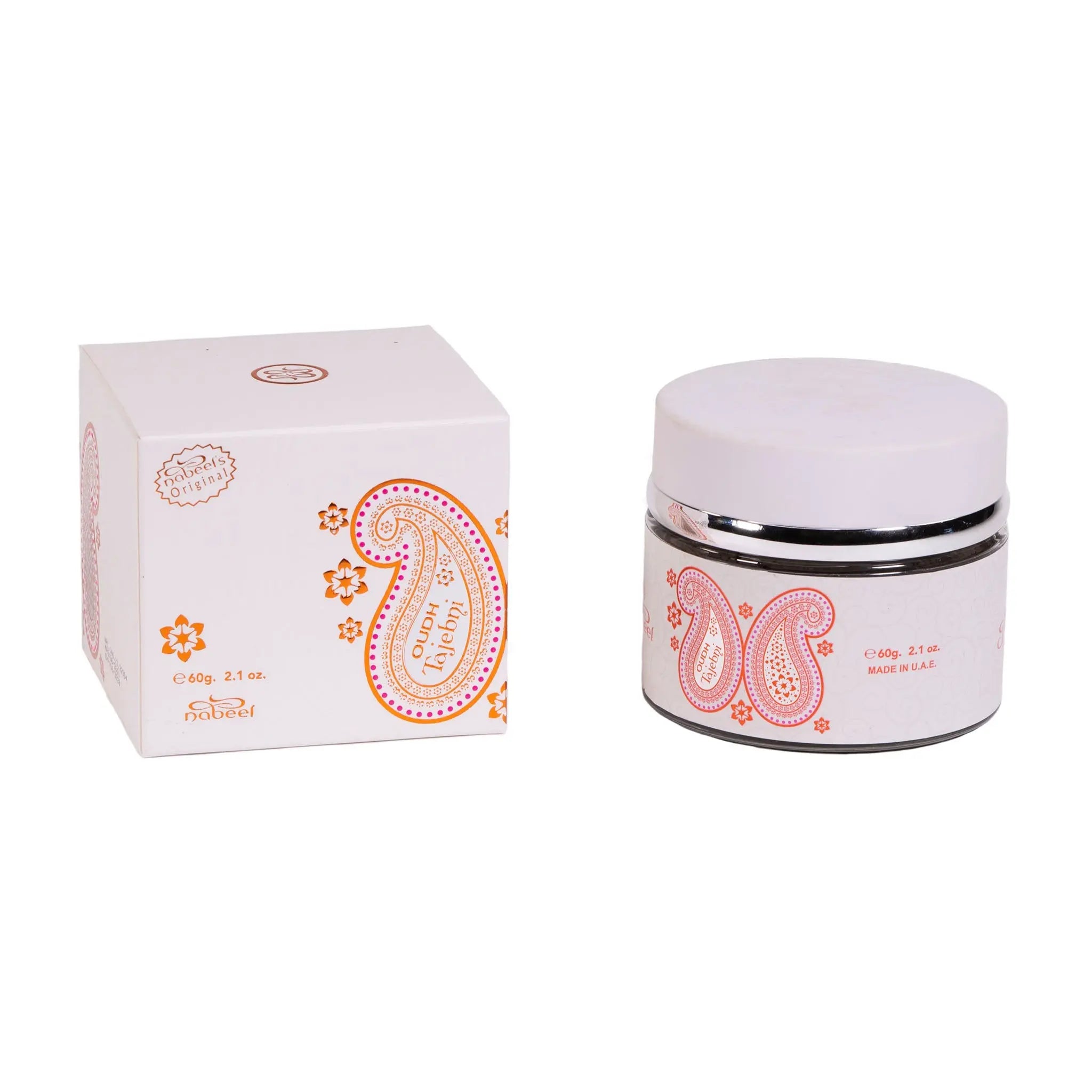 The image showcases a product called "OUDH" in white packaging with orange details. There's a white box and a jar, both adorned with paisley and floral motifs. The box and jar have labels with the product's name and weight, "60g, 2.1 oz.", and a note "MADE IN UAE". The jar has a white lid with a silver band.