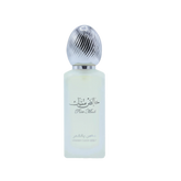 The image features a bottle of hair mist with a pastel-colored body, likely a frosted glass with a light blue tint. The cap is metallic silver with a ribbed texture, resembling a polished metal. On the bottle, there is Arabic calligraphy above the English words "Pure Musk." Below this, in a smaller font, the text "FRESH HAIR MIST" is visible.