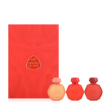 A set of three Gissah perfume bottles in varying shades of red, displayed in front of a red box labeled "Shades of Love." The bottles are octagonal with intricate embossed designs and smooth caps, and they come in peach, vibrant red, and deep red hues. The box features elegant patterns and the Gissah brand name, complementing the theme of love and passion conveyed by the colors and design of the bottles.