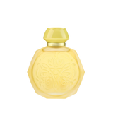 A yellow octagonal perfume bottle with intricate embossed designs on the front. The bottle features a matching yellow cap and a gold collar, adding a touch of elegance to its vibrant appearance. The design elements give the bottle a sophisticated and luxurious look, perfect for a high-end fragrance.