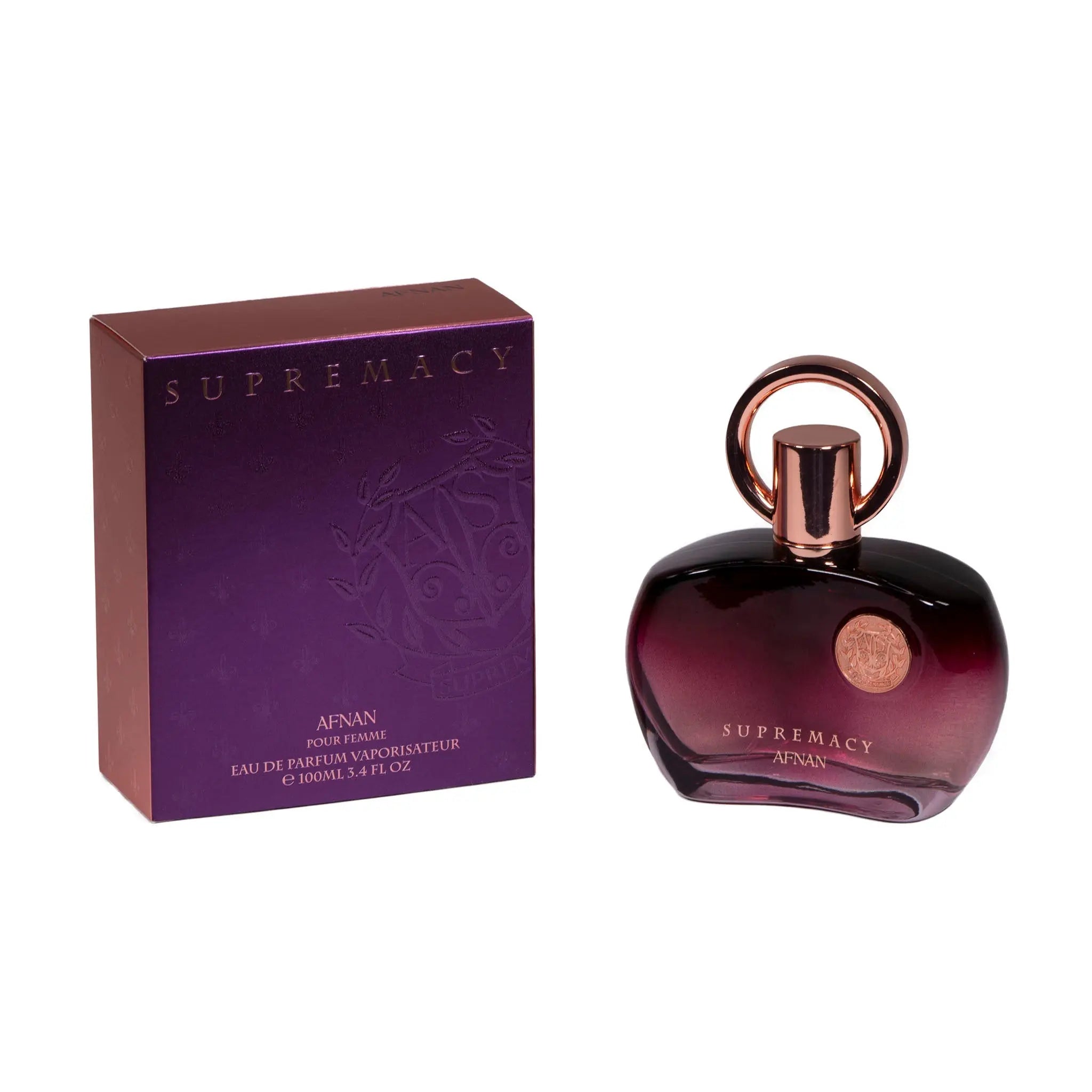 The image displays a perfume set which includes a bottle and its packaging box. The bottle has a dark purple gradient color with a glossy finish and a rose gold cap with a loop design on top.  Next to the bottle is its box, in a matching purple shade with metallic sheen, and the brand and perfume name embossed on it. The box specifies that it is for women and contains "Eau de Parfum Vaporisateur" of 100ml or 3.4 fl oz. The overall presentation is elegant and suggests a luxurious fragrance product.