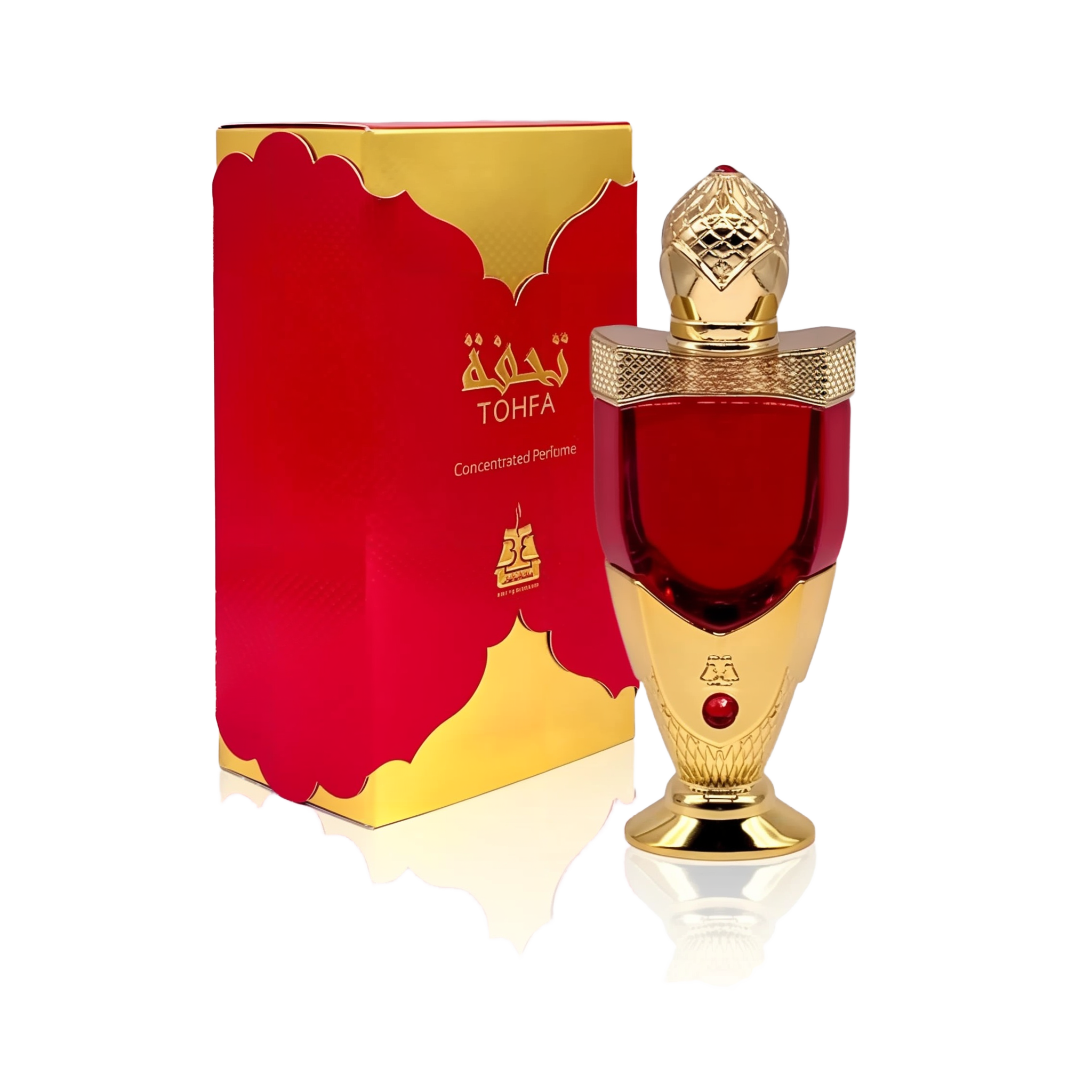 The image shows a luxurious perfume bottle next to its packaging. The bottle has a rich red color with a golden cap, detailed with intricate patterns and topped with a clear faceted finial that resembles a gem. The base and neck of the bottle also feature golden accents. A red gem is embedded in the golden section of the bottle. The packaging box is red with a golden border and carries the brand name "TOHFA" in gold lettering.