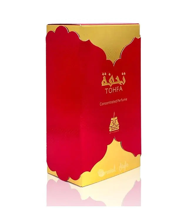 The image displays a perfume box with a striking design. The primary color of the box is a vibrant red with a glossy finish, and it features elegant gold trim along the top and bottom edges. The brand name "TOHFA" is written in the center in stylized gold lettering, with the words "Concentrated Perfume" just below it. Below the text, there is a gold emblem that looks like a palace or crown, contributing to the luxurious appearance of the packaging.