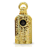 The image shows a luxurious perfume bottle. The bottle has a golden color with intricate arabesque patterns carved into its metal exterior, giving it a very ornate and decorative appearance. The cap of the bottle is also golden and has a circular handle, likely for aesthetic purposes. In the center of the bottle, there is a black label with the word "BAYAAN" written in stylized white Arabic script. The background is plain, highlighting the detailed craftsmanship and opulent design of the perfume bottle.