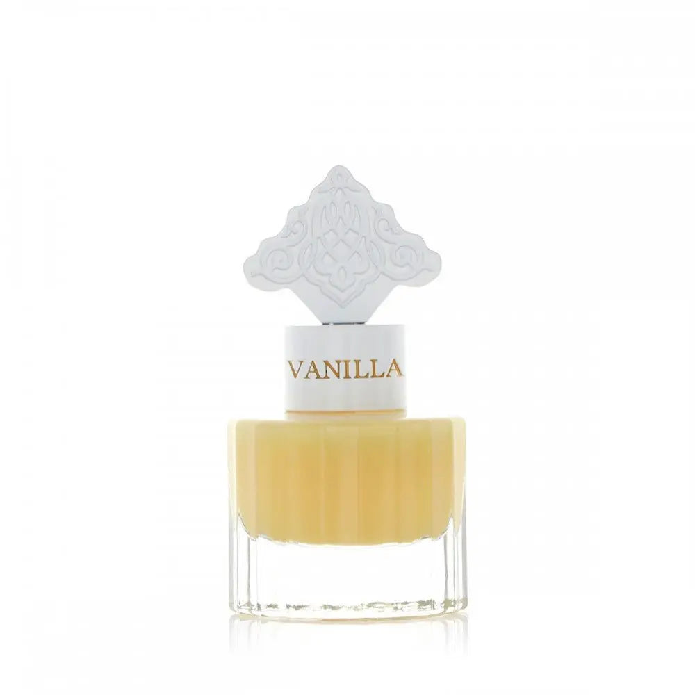 The image features a clear glass bottle with a yellow-colored liquid, suggestive of a vanilla-scented product. The bottle has a white cap with the word "VANILLA" printed on it in a color that complements the liquid. Atop the cap is a decorative white design with an intricate pattern, possibly inspired by Middle Eastern or Islamic art. The aesthetic of the bottle suggests an elegant fragrance, likely a special vanilla musk formulated for hair.