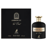 This image features a perfume bottle and its packaging from Maison Alhambra's "Amberley Pur Oud" line. On the left is a square black box with the text "Amberley Pur Oud" in golden lettering, a stylized arched window logo at the top, and a golden stag emblem at the bottom. The box also states the bottle contains "100ml" and "3.4 fl oz" of "Eau de Parfum". On the right side of the image is the black perfume bottle with a round golden cap, matching the description on the box.