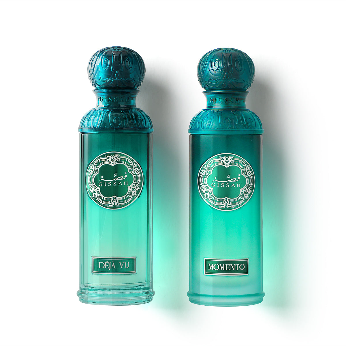 Gissah Déjà Vu and Momento turquoise perfume bottles with ornate teal caps side by side on white background.