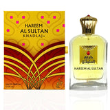 The image features a perfume called HAREEM AL SULTAN by Khadlaj, alongside its packaging. The perfume bottle is rectangular with a clear glass design, displaying the golden-colored fragrance inside. It has a regal-looking cap and a label with the perfume's name in both Arabic and English script, accented by a graphic that includes a red gemstone design. The packaging has a vibrant orange and yellow color scheme with red decorative elements.