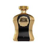 A photo of the Highness V Black EDP 100ml perfume bottle, featuring a striking contrast of polished gold and deep black. The central black panel is framed by a textured gold surface with a luxuriously designed crest bearing the name 'HIGHNESS' above and the Roman numeral 'V' below. The cap is a smooth gold that complements the elegance of the bottle design, suggesting a scent of regal and sophisticated character.