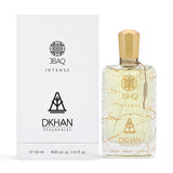 The image features an elegant clear glass perfume bottle with golden geometric patterns and the label "3SHQ INTENSE" on the front, alongside the "DKHAN FRAGRANCES" emblem. It is paired with its packaging box, which reflects the same design aesthetic in black print on a white background. The bottle is capped with a golden top and has a beige tag on the side. Both the bottle and the box display the volume information "100 ml", "98% vol.", and "3.34 fl. oz."