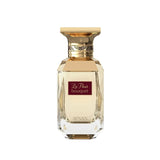 The image features a classic and elegant perfume bottle. The bottle is transparent with a multifaceted design that reflects light, giving it a luxurious crystal appearance. It has a broad, golden cap with decorative elements around its neck. On the front of the bottle, there is a maroon label with the text "La Fleur bouquet" in white cursive script, and below on the bottle's base is the brand name "AFNAN" in capital letters. 
