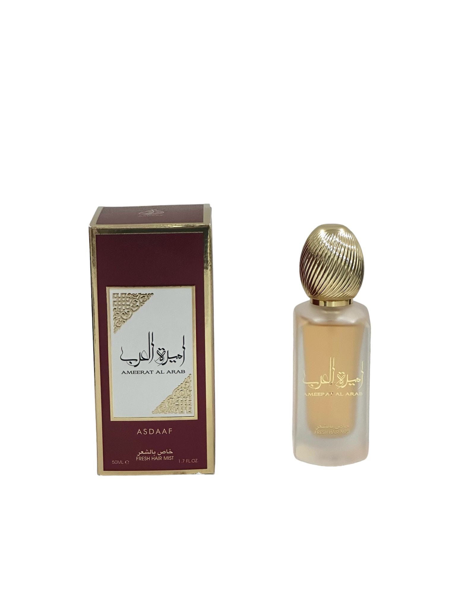  The image displays a maroon and gold packaging box alongside a frosted glass perfume bottle with a gold ribbed cap. The box has the name "AMEERAT AL ARAB" in white against a gold background on both the English and Arabic scripts, with the brand "ASDAAF" below it. Below on the box, it states "50ML / FRESH HAIR MIST / 1.7 FL.OZ."