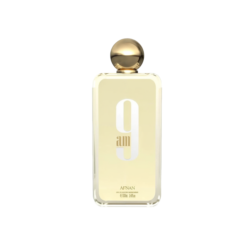The image depicts a minimalist-designed perfume bottle with a golden cap. The bottle is transparent, revealing a pale yellow liquid inside, suggesting the perfume color. On the bottle's front, in large, white, modern font is "9 am," with the lowercase "am" nestled within the number 9. Below this, in smaller uppercase letters, reads "AFNAN."  The bottle is centered against a white background, which emphasizes the simplicity and elegance of the design.