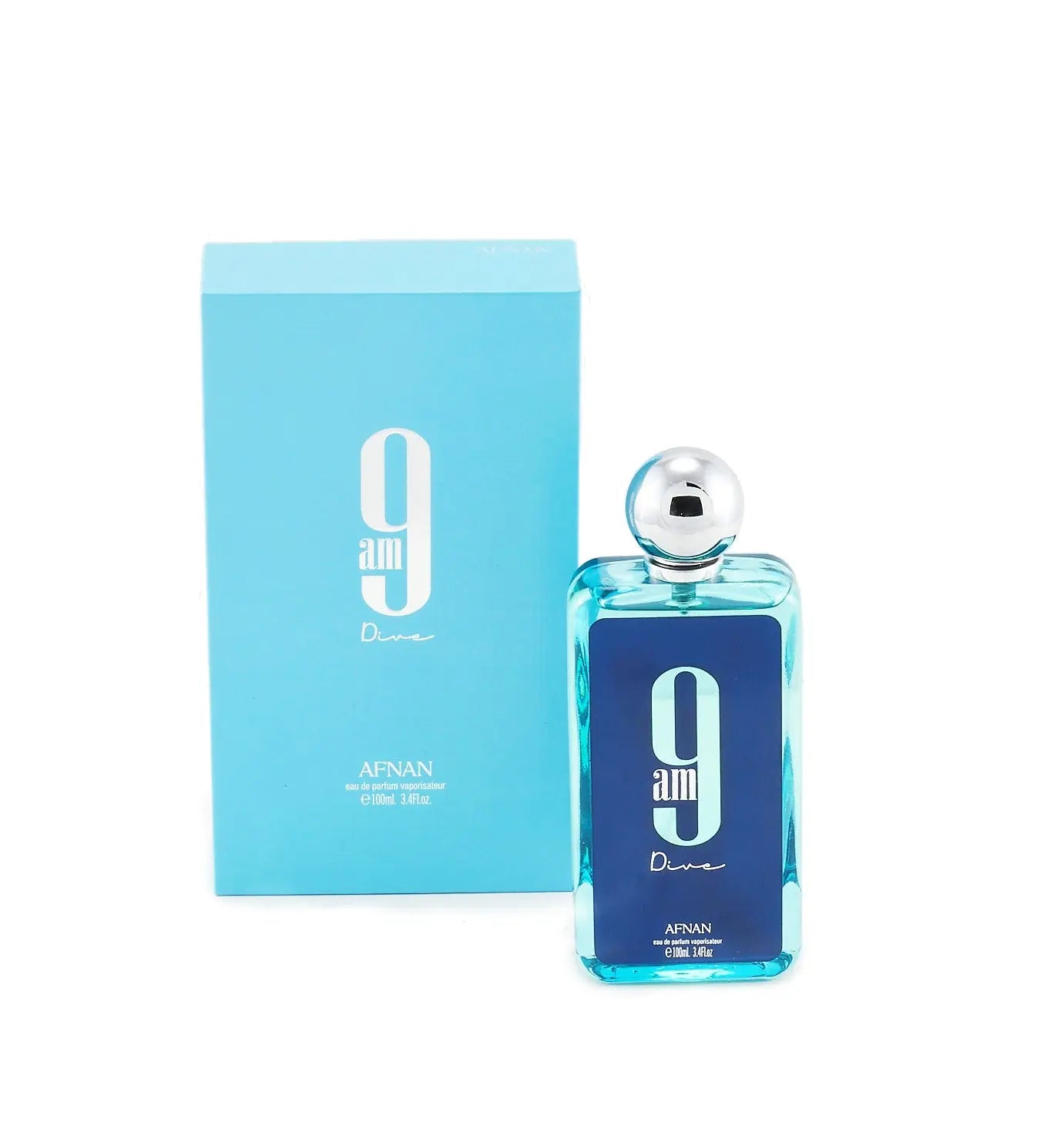 The image features a rectangular glass perfume bottle with a transparent blue tint, accompanied by its matching packaging box. The bottle has a large white "9" and the text "am" in a smaller font, with "Dive" written in cursive below it. Above the "9," there's a silver spherical cap. "9 am Dive" and "AFNAN" branding, along with the text "eau de parfum vaporisateur" and the volume "100ml | 3.4fl.oz". The background is a plain white surface with a slight shadow cast by the bottle and box. 