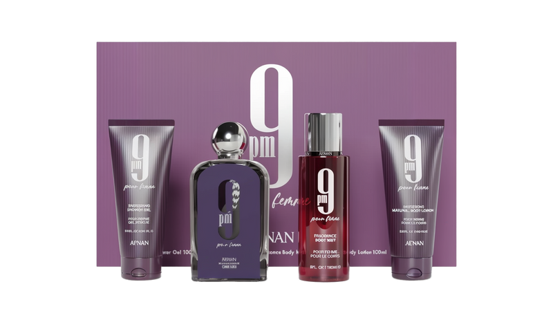 The "9 PM Pour Femme" fragrance gift set by Afnan Perfumes presented against a purple and silver striped background. The set includes an energizing shower gel (100 ml) on the left, a central purple perfume bottle with a silver cap, a fragrance body mist (