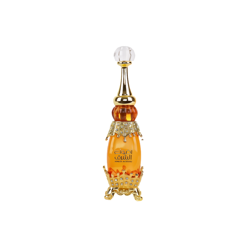 Elegant bottle of Adwaa Al Sharq with jewel-studded gold base and crystal-clear pointed stopper.