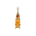 Elegant bottle of Adwaa Al Sharq with jewel-studded gold base and crystal-clear pointed stopper.