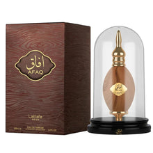 The image features a perfume product display consisting of a bottle and its packaging. The bottle of AFAQ Latifa perfume, resembling wood grain with golden accents, is placed within a clear glass dome on a black pedestal. The pedestal has the brand name "