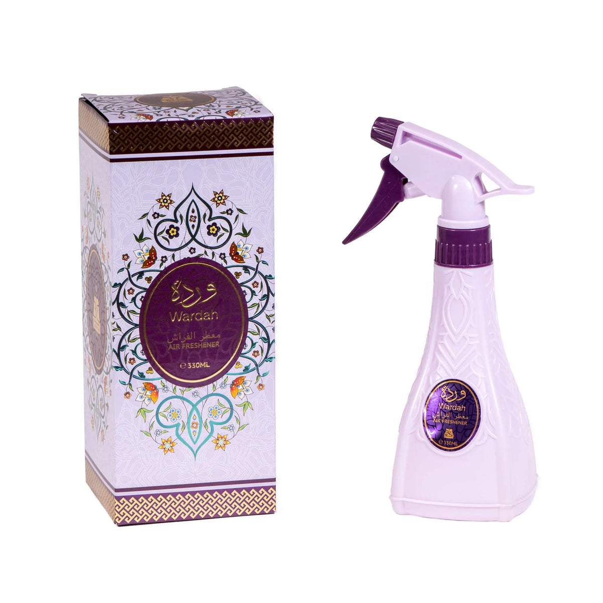 The image displays a product set that includes an air freshener spray bottle and its packaging box. The spray bottle is light purple with a darker purple spray trigger. It features a black label with gold and purple detailing, including Arabic script and the name "Wardah" in both Arabic and English. The packaging design incorporates traditional Middle Eastern motifs, and the entire set is displayed against a neutral backdrop, which allows the details and colors of the product to stand out.