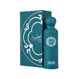 A product image showing the Gissah “Akoya” perfume: a tall, rectangular teal gift box decorated with a white, Arabic-inspired arabesque pattern and the brand name “Gissah” (in Arabic and English) with “Akoya” printed beneath, paired with a matching cylindrical teal perfume bottle featuring an intricately carved rounded cap.