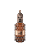 A product shot of Le Falcone Niche Collection’s “Al Majd” perfume bottle against a white background: a tall, amber-colored glass vessel with a diamond-cut texture and a polished bronze plaque displaying Arabic calligraphy above the words “Al Majd.” It’s crowned by an ornate bronze cap sculpted into a stylized warrior’s helmet with a crest-style loop at the top, conveying a sense of luxury and strength.