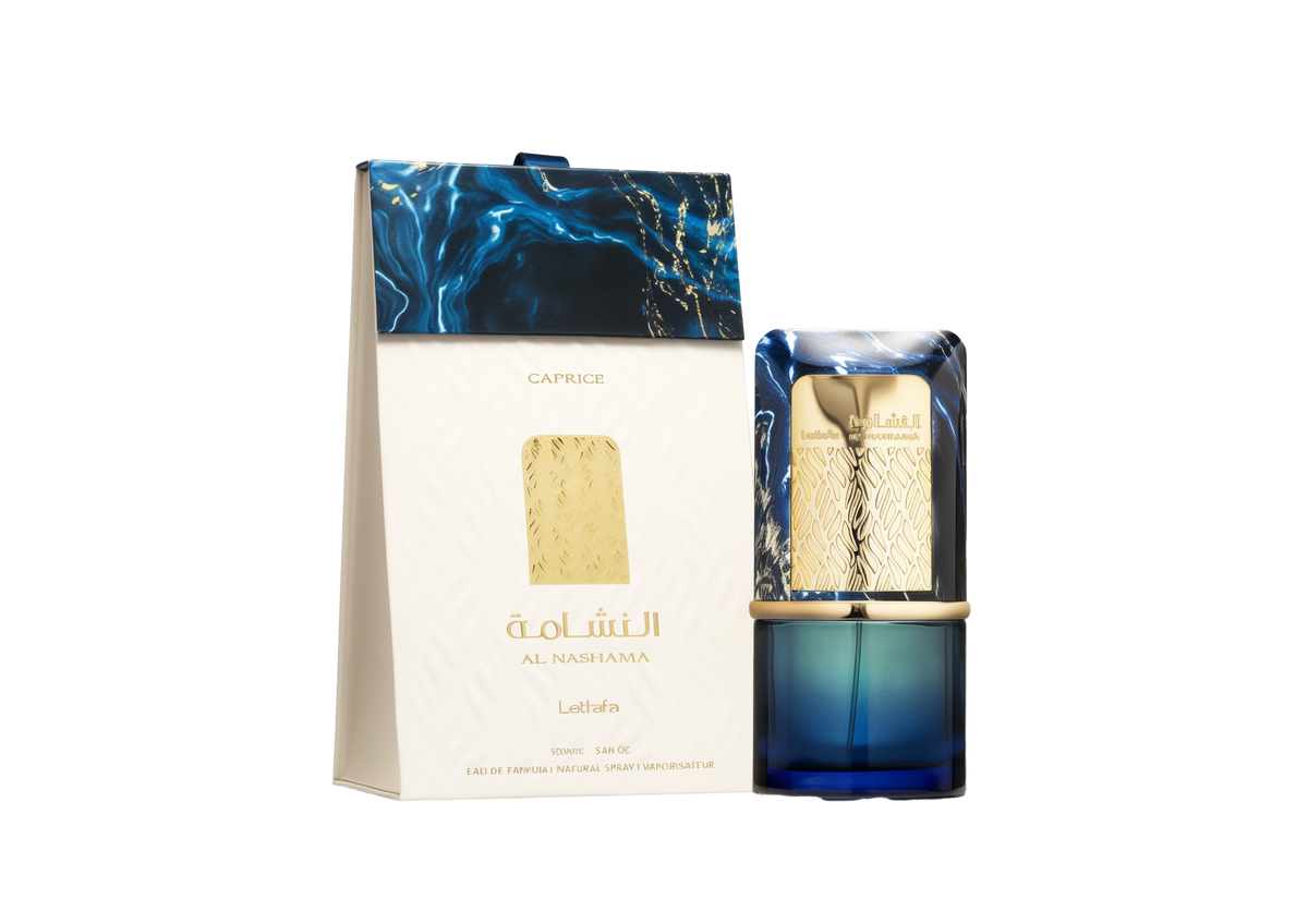 A deep-blue glass perfume bottle with a decorative gold band and a marbled blue-and-gold rectangular cap stands beside a matching white box. The box features a raised pattern, gold accents, and navy-blue marbling at the top, with the product name “Al Nashama” and “Lattafa” printed in gold.