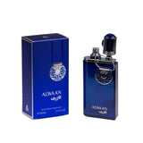 The image features a perfume bottle with the name "ALWAAN" and its corresponding dark blue box. The bottle is a rich blue with a silver emblem and a distinctive cap that looks like a miniature faucet handle, adding a unique touch to the design. The box has the name "ALWAAN" in white with the Arabic translation below it and a matching silver emblem. It also specifies "Natural Spray Vaporisateur" and "E100ML 3.4 FL OZ" indicating the content and volume.