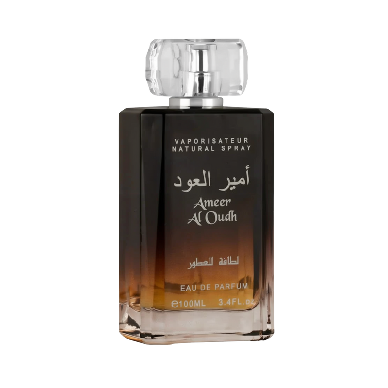 A close-up view of the Ameer Al Oudh by Lattafa Perfumes bottle. The perfume bottle has a gradient color scheme, transitioning from light amber at the base to dark brown towards the top. The bottle has a clear, faceted cap and silver text in both Arabic a