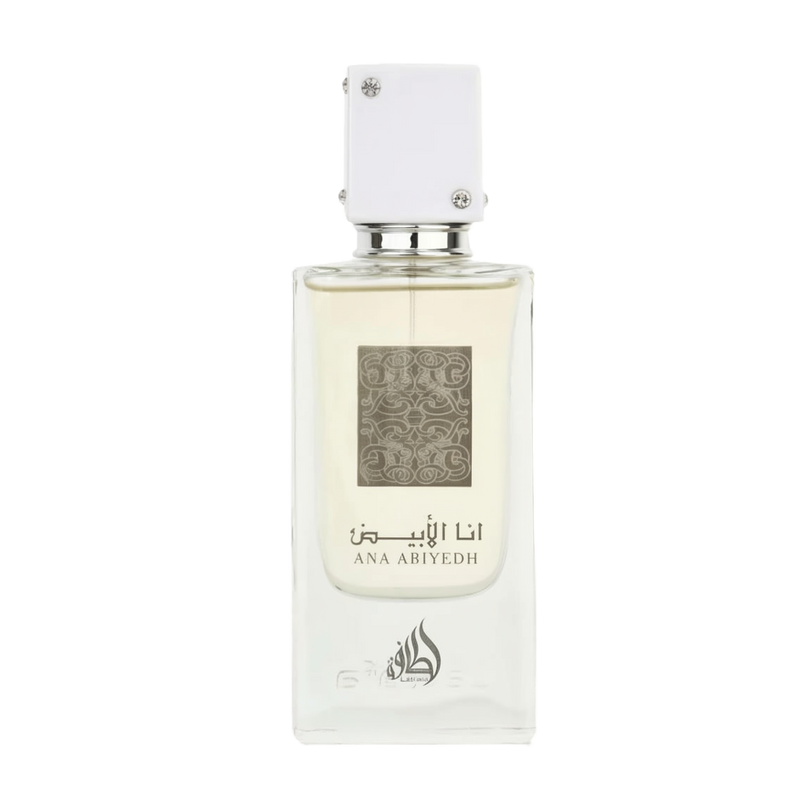 A clear rectangular bottle of Ana Abiyedh Eau de Parfum by Ard Al Zaafaran Lattafa Perfumes. The bottle features a minimalist design with a white cap adorned with small silver accents. The front of the bottle displays intricate silver patterns along with the fragrance name "Ana Abiyedh" in both Arabic and English.