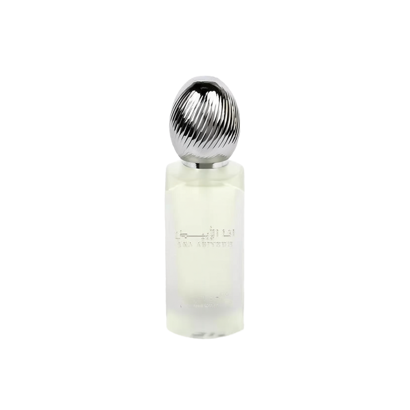  The image shows a frosted glass perfume bottle with a metallic, ribbed cap. The bottle has text in Arabic and English that reads "ANA ABIYEDH" indicating the fragrance name. The design is minimalist and modern, and the translucency of the bottle suggests a light or fresh scent, likely intended as a hair mist, as indicated by the product's volume labeled at the bottom "50ml."