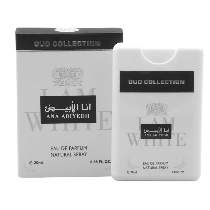 The image shows a perfume product from the 'Oud Collection' by 'Ard Al Zaafaran' named 'Ana Abiyedh'. The set includes a perfume bottle and its packaging box, both presented in grayscale tones. The box has a black lid with 'OUD COLLECTION' written on it, and the body is gray with decorative emblem and branding in black and lighter gray shades. 