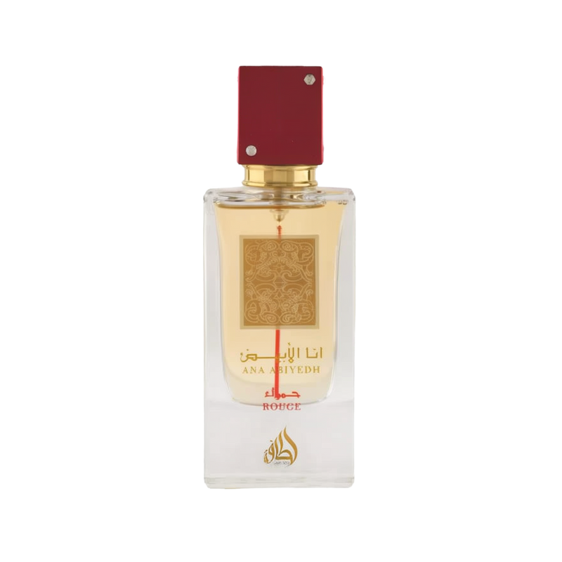 Image of a rectangular clear glass perfume bottle with a red cap embellished with two crystals. The bottle features a gold label with intricate arabesque designs and Arabic calligraphy that reads '??? ????' (Ana Abiyedh), with 'ROUGE' printed in red below. Below the gold label is the brand logo in gold with a flame-like design and the word 'Lattafa'. The perfume liquid appears to be a pale amber color, and the overall design suggests luxury and exotic allure.